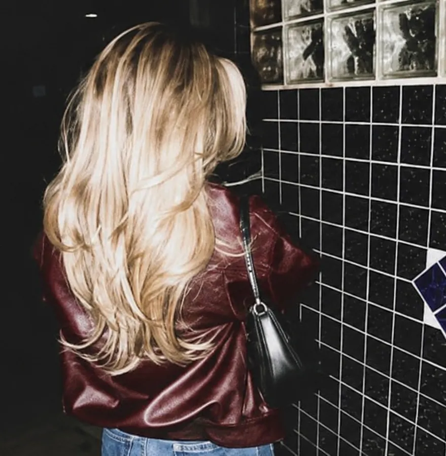 Blonde girl wearing a red leather jacket