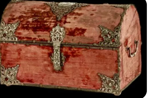 This is a trunk covered in crushed red velvet with old brass clasps and edges