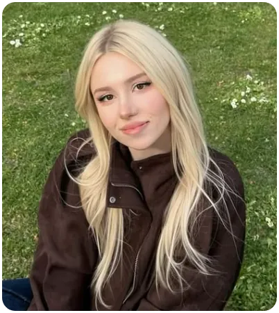 Kitty-Mae Merritt, brown jacket, fitting in a field of grass