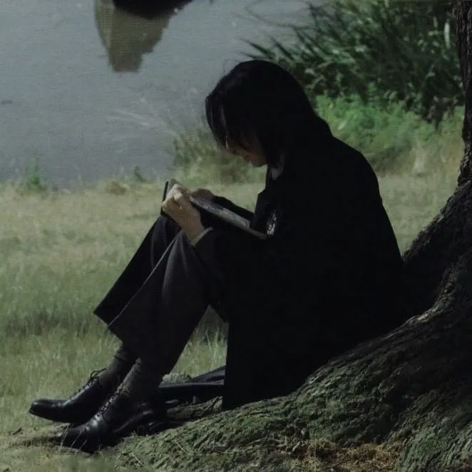 person reading under tree
