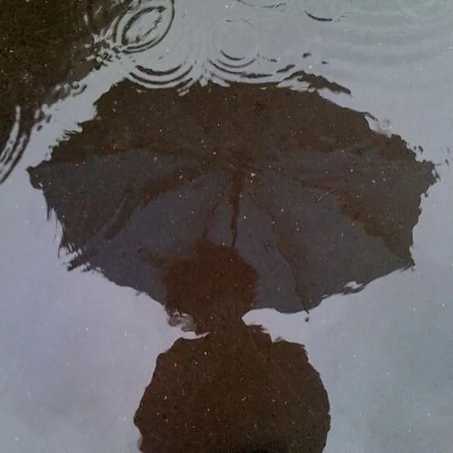 person in the rain with an umbrella