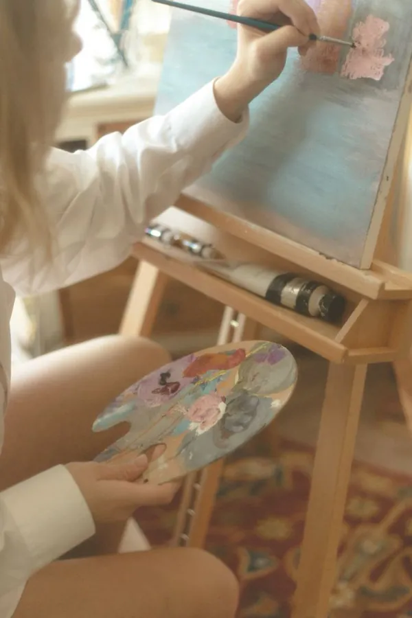 a blonde girl painting